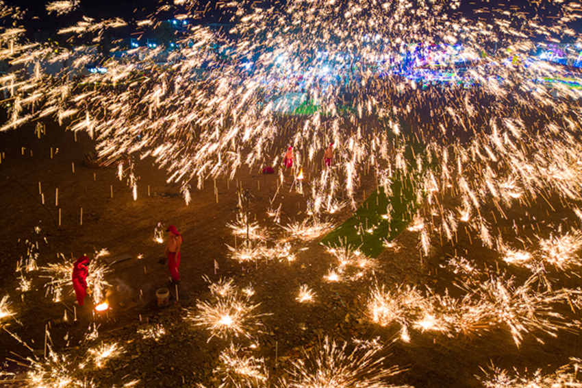 2月1日，傳統(tǒng)匠人在眉山市彭山區(qū)金燭村的萬家水碾夜市為群眾表演國家級非遺“打鐵花”。翁光建攝